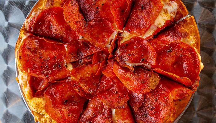 Legens Pizza with multiple Texas locations ultimate pepperoni pizza.